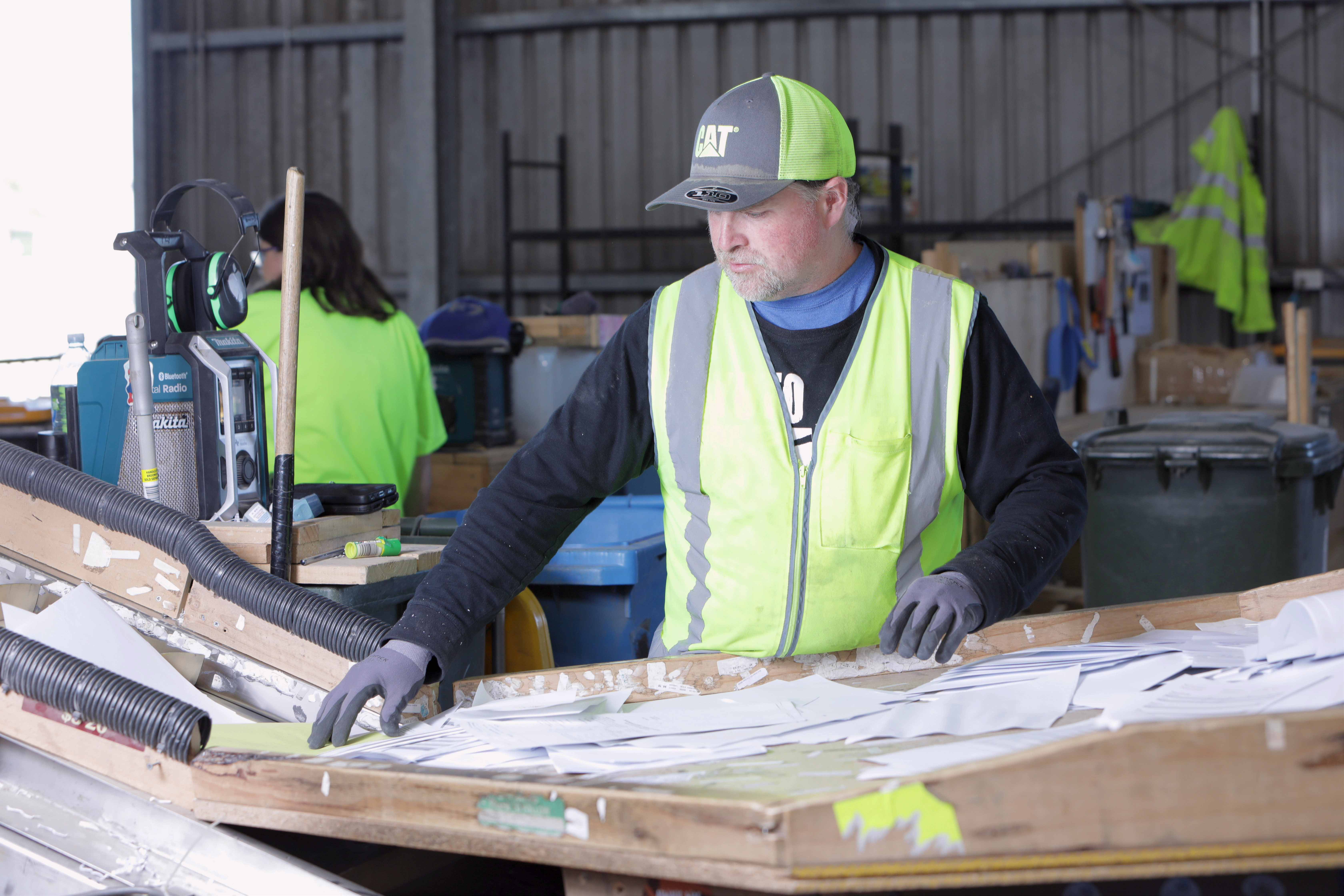 Person cutting down boxes as part of a recycling program