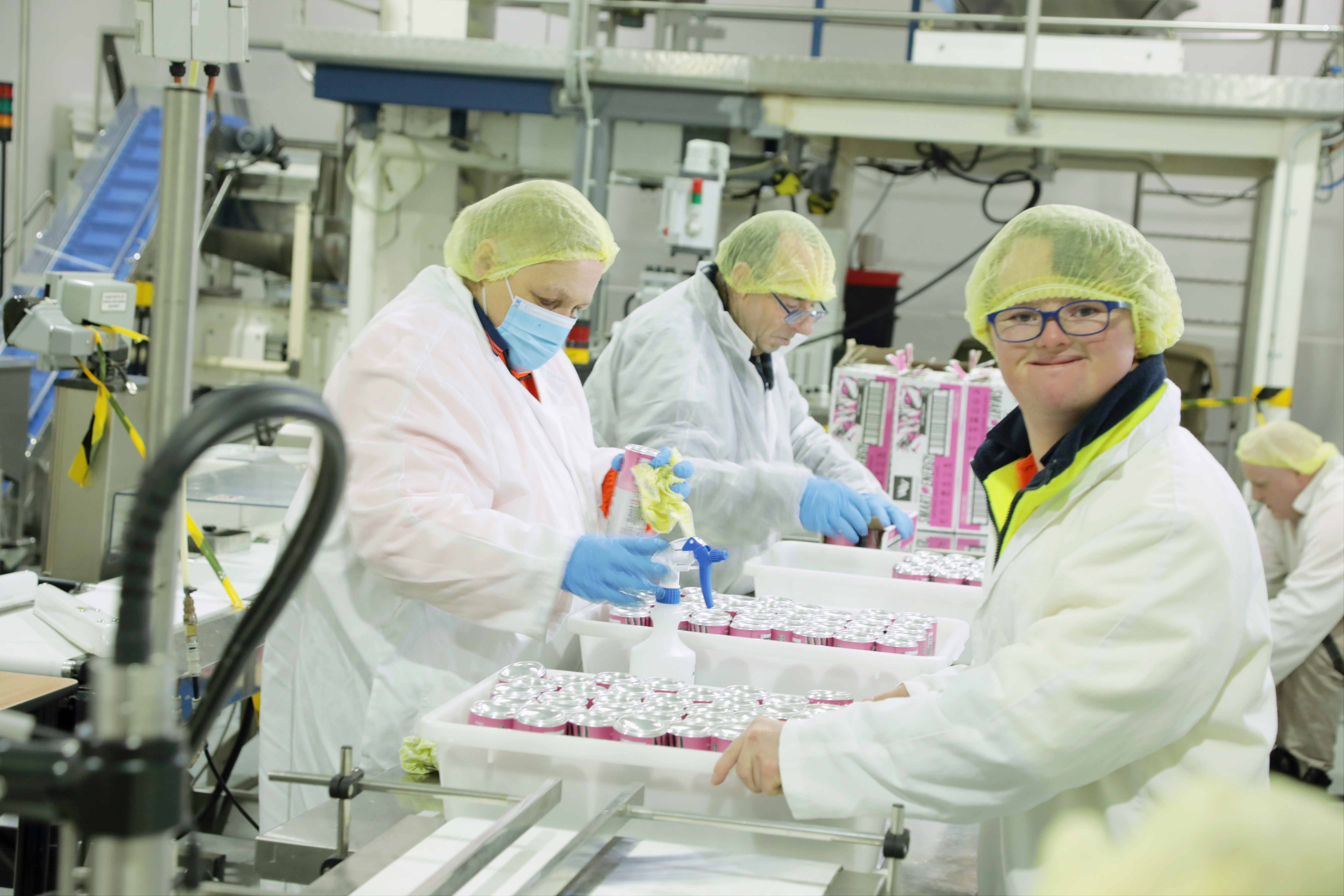 Group of people working as a group to pack food items 