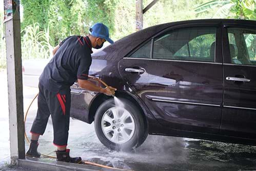 Person washing a car as part of a Support Employment program