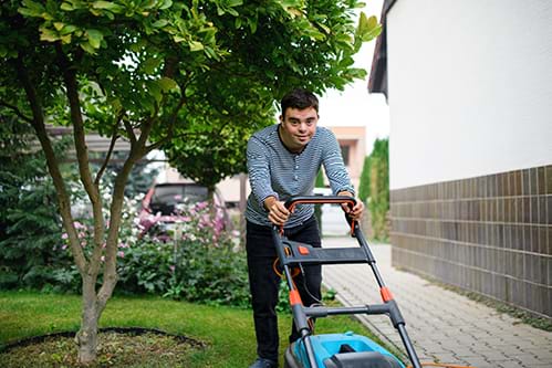 Person with a disability mowing a lawn