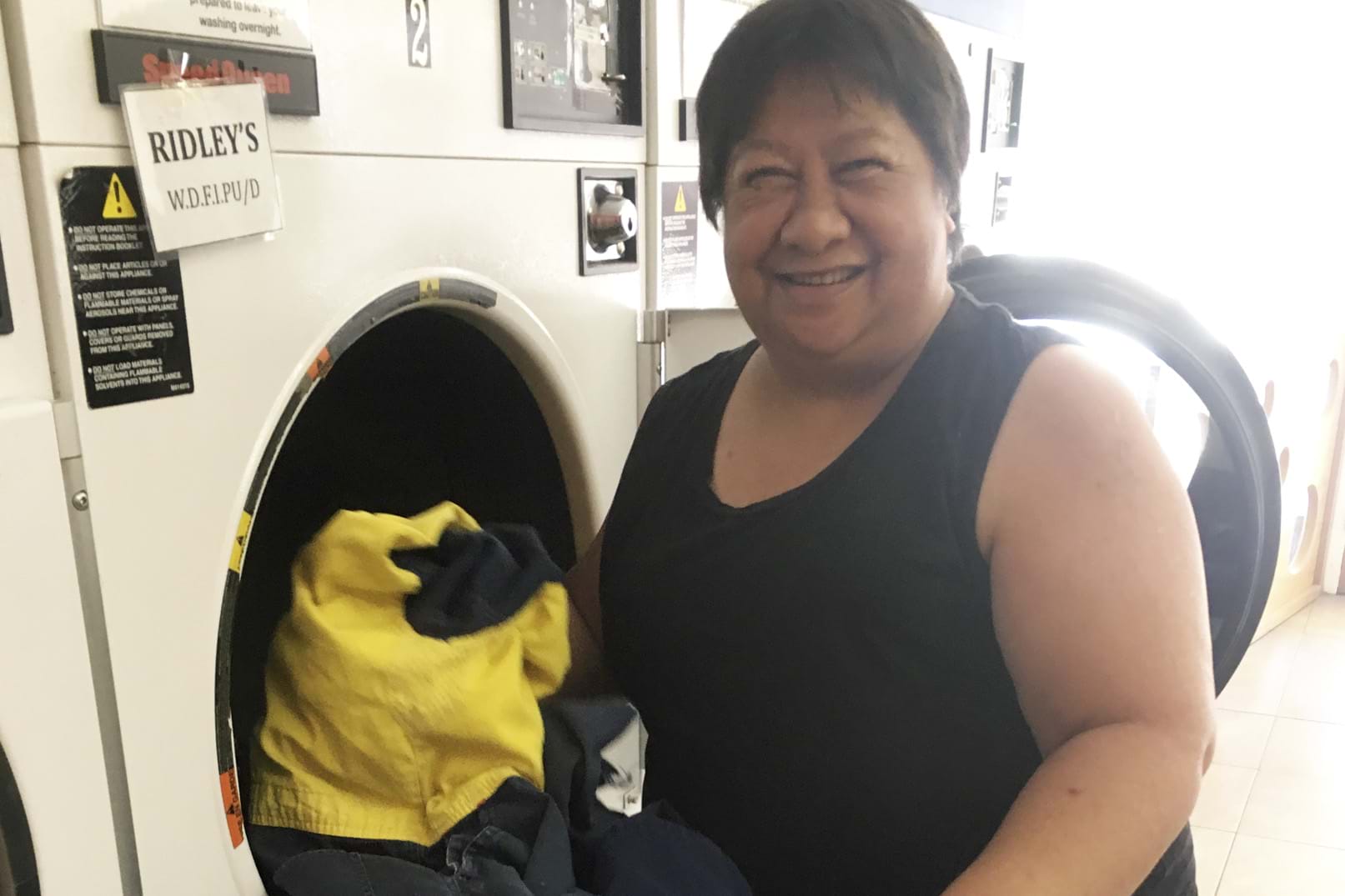 Person with a disability removing items from a washing machine