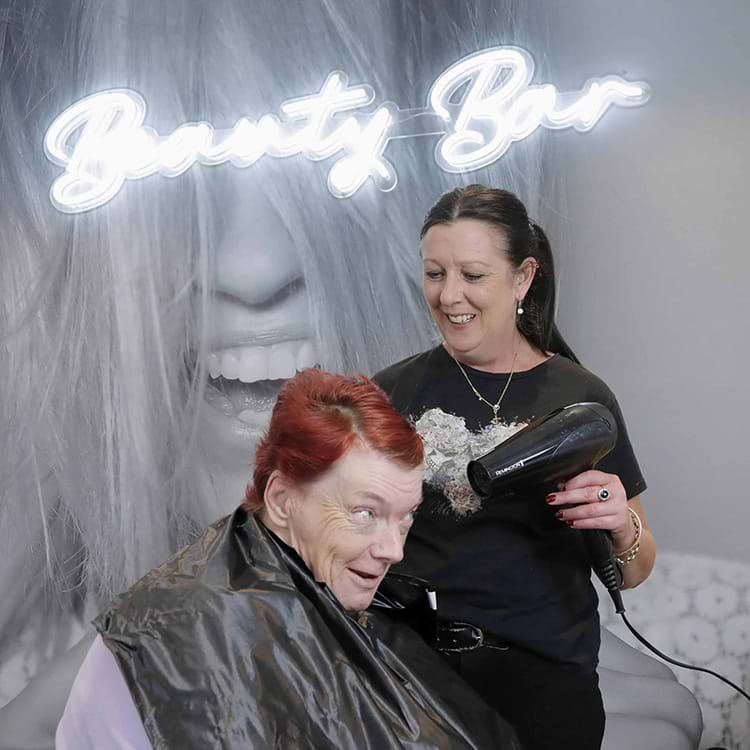 Person having their hair styled by a hairdresser in the McCallum beauty bar