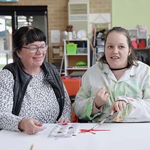 Young person with support worker in the McCallum art room