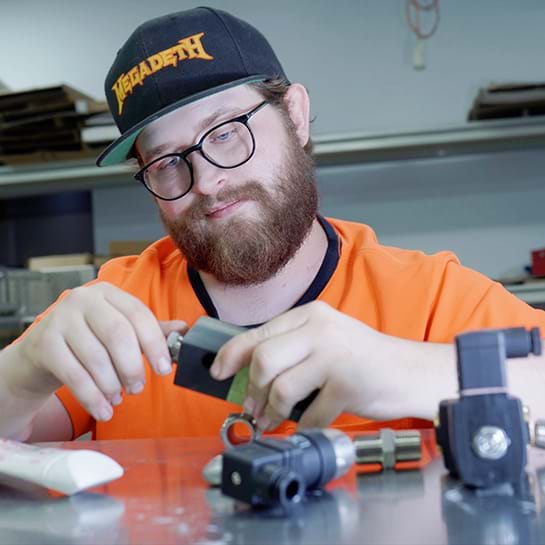 Person with a disability working to assemble some machinery